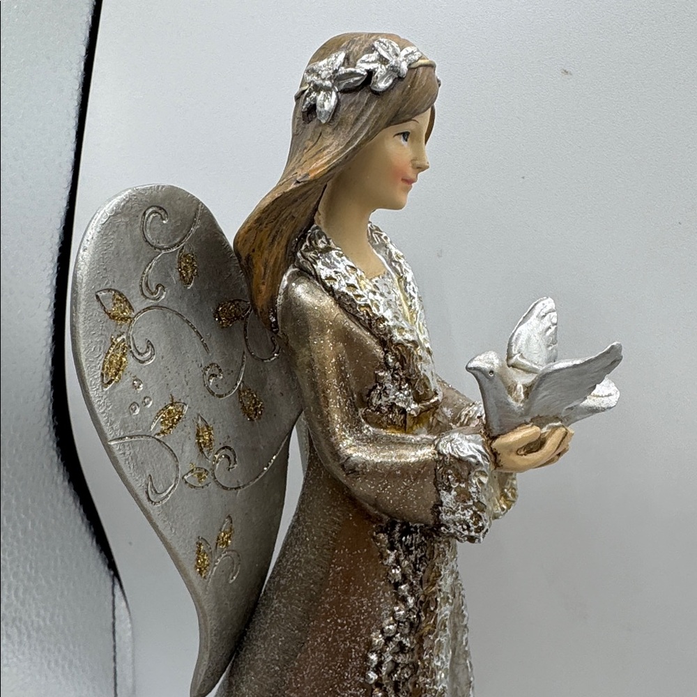 Angel Figurine holding a dove shimmering gold and silver design 12” tall